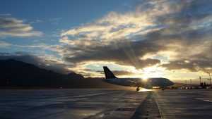 An airplane taking off at sunrise.