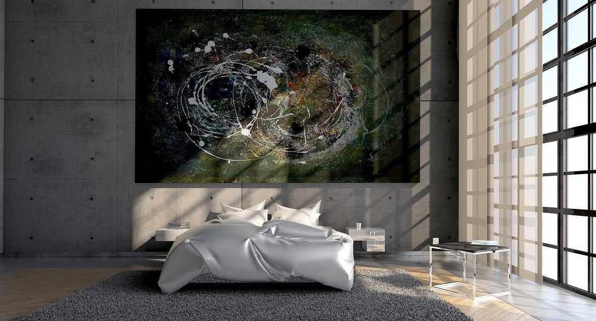 A bedroom with a bed, a carpet and a large abstract painting on the wall