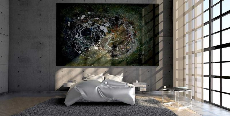 A bedroom with a bed, a carpet and a large abstract painting on the wall