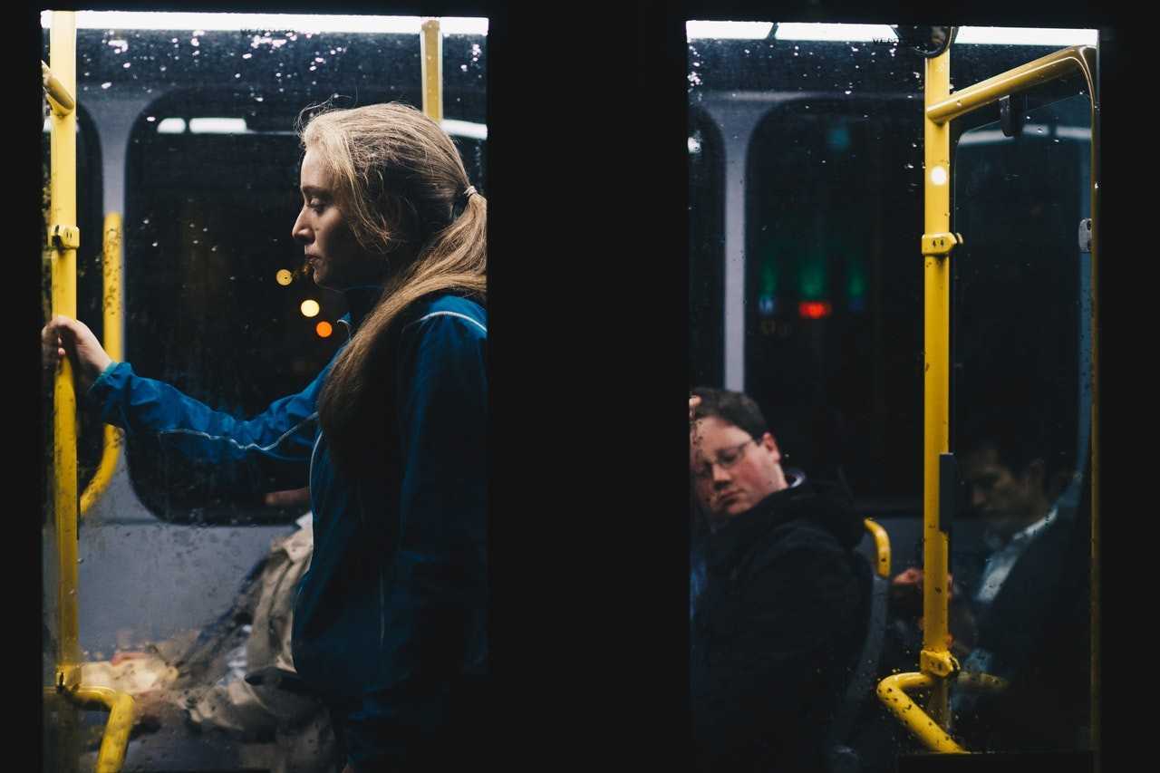 Four people using public transportation at night