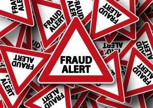 A lot of road signs saying "FRAUD ALERT"