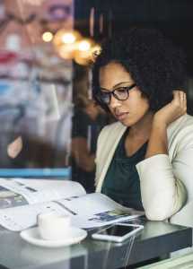 African-American woman looking through moving company reviews.
