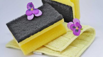 Two purple flowers, two yellow sponges and a yellow towel