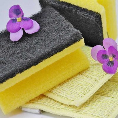 Two purple flowers, two yellow sponges and a yellow towel