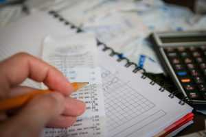 Person going through tax calculations and receipts.