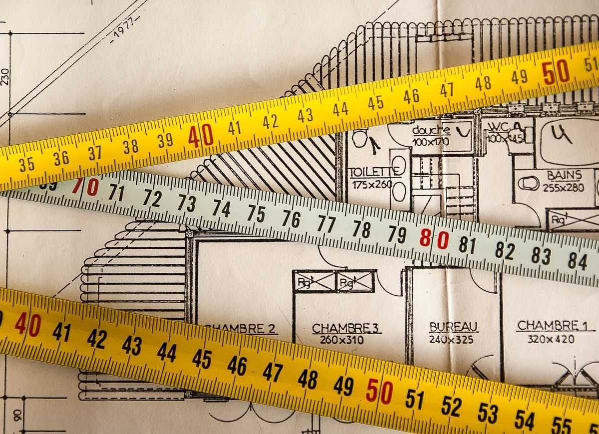 Measuring tapes and a house plan