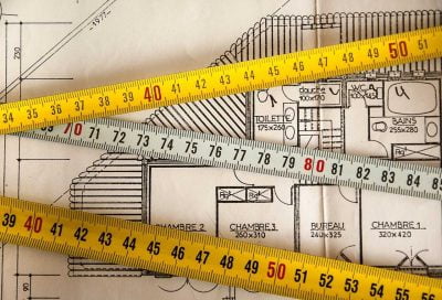 Measuring tapes and a house plan
