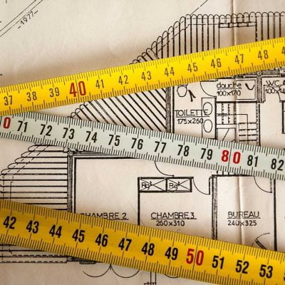 Measuring tapes and a house plan
