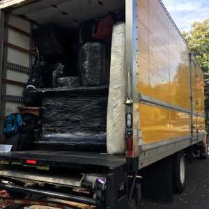 Packing a moving truck in progress - a large truck loaded with packed items
