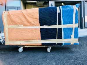 A large item wrapped in padding material secured with tape