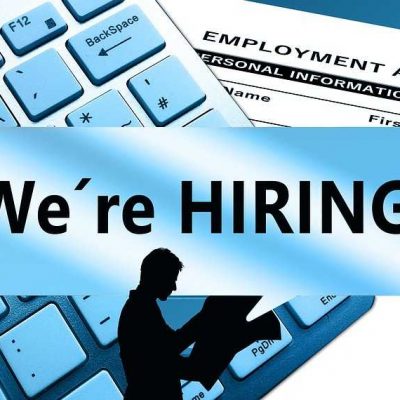 A male silhouette holding newspapers, "We're hiring" written across the picture, a keyboard and an employment application form in the background