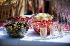 A house party as a way to reward friends for helping you move - Bowls full of food, glasses and toothpicks on a table