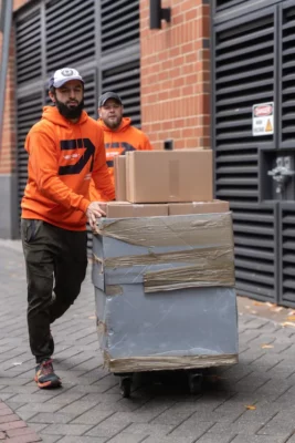 moving team carrying boxes in Middlesex apartment